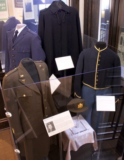 Picture of a display of four mannequins wearing military uniforms from different wars and different time periods.