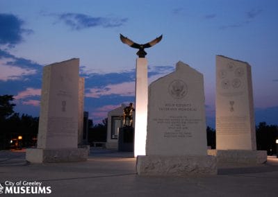 Image of the pillars and statues at the Veterans Memorial at sunset.