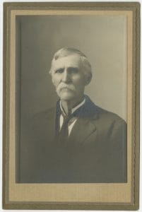 Portrait of an older man with white hair and mustache